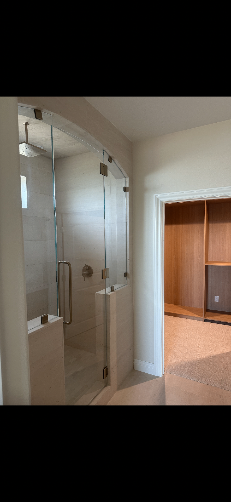 Custom glass shower with marble tile